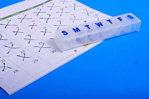 empty pill box on calendar with days crossed off