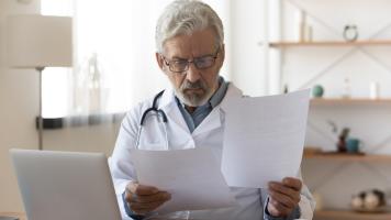 Doctor looking at papers