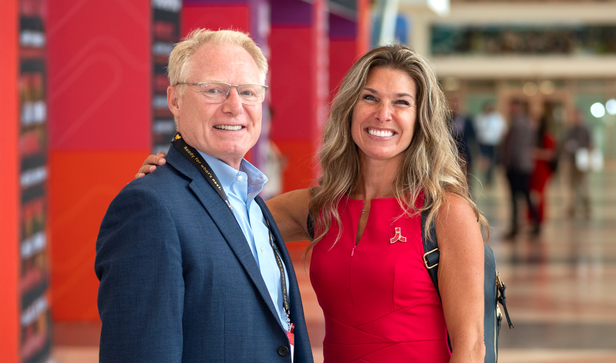 Attendees smiling in a hallway