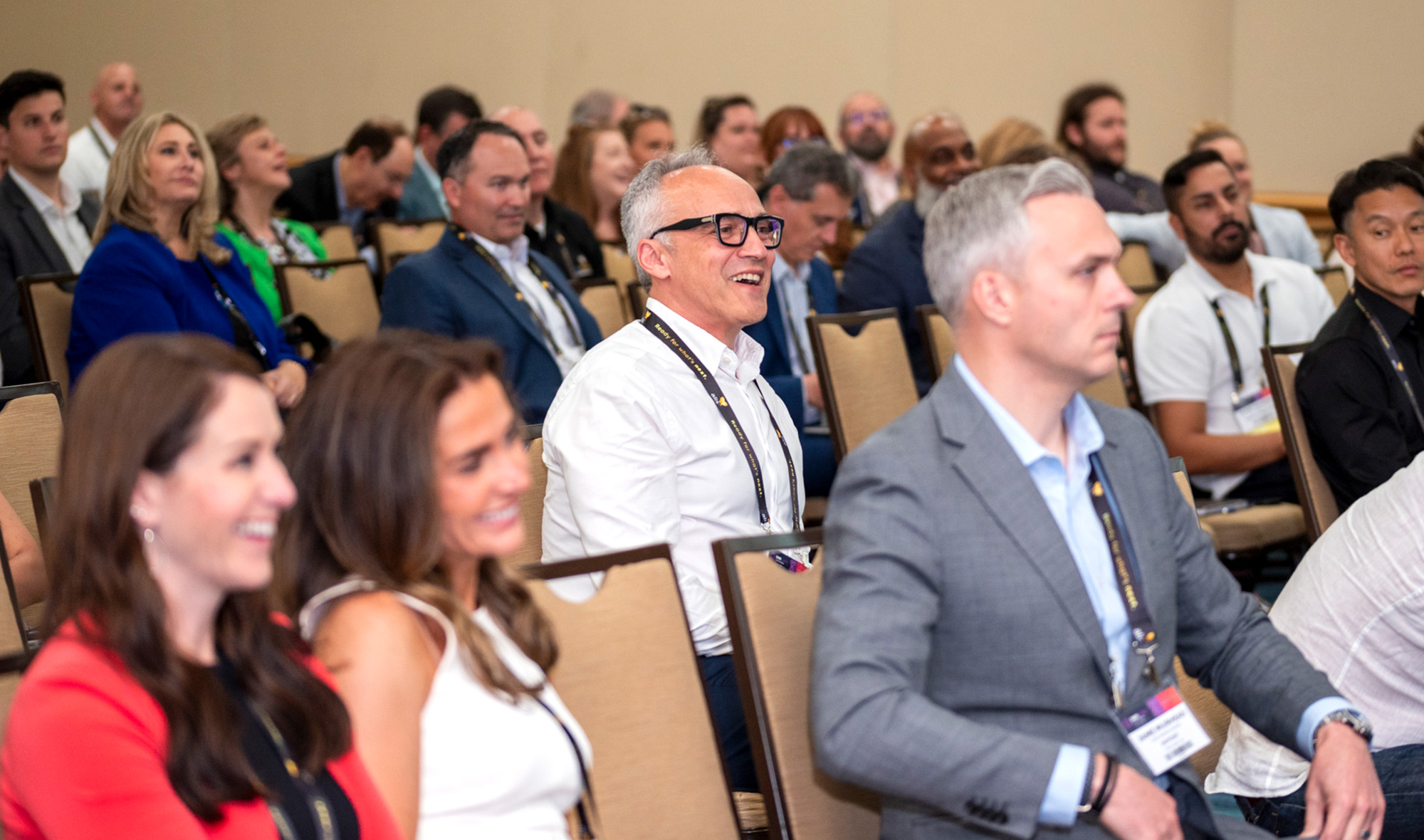 Attendees intently watching a session speaker