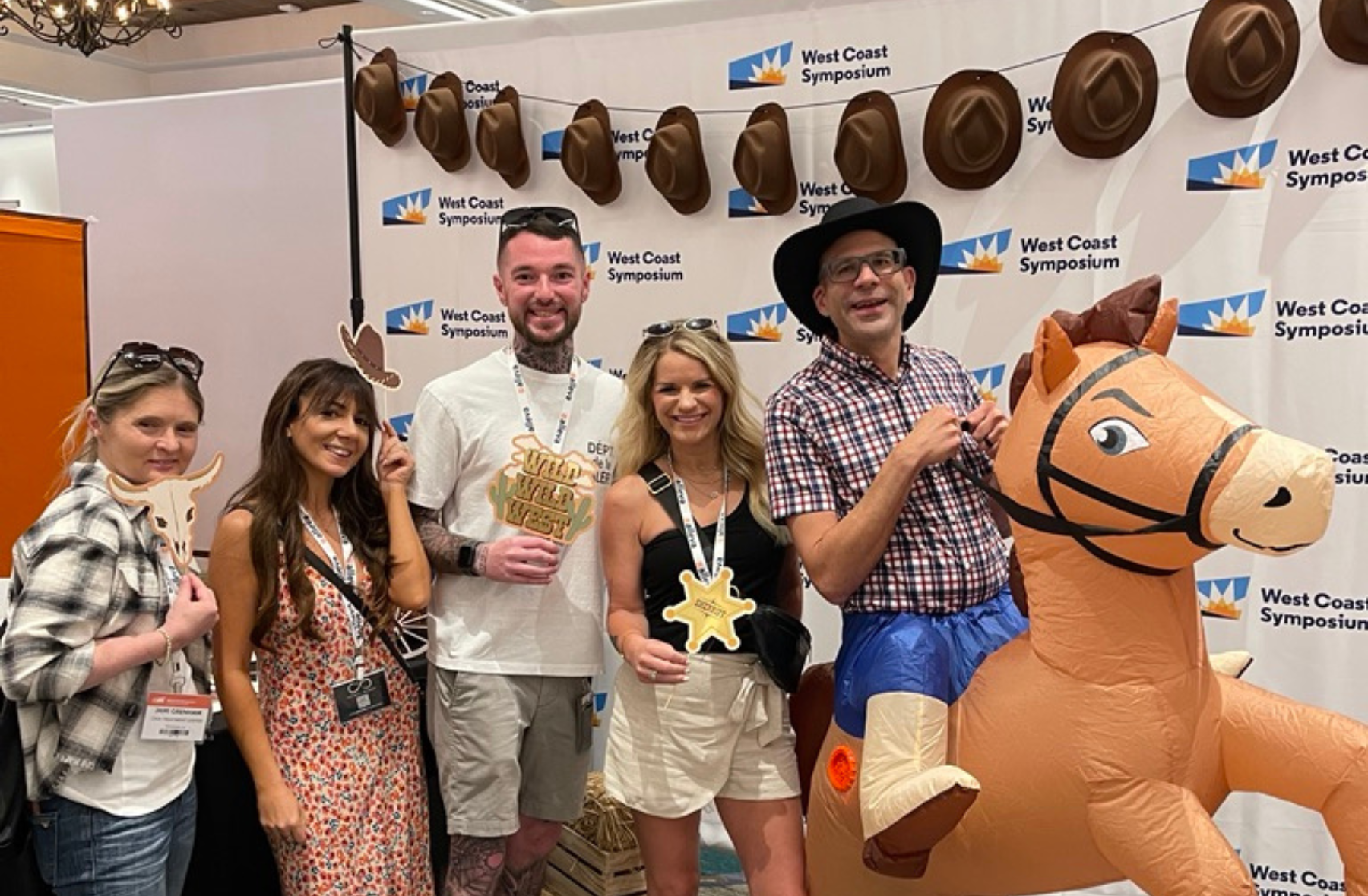 Attendees smiling for Rodeo for Recovery Day at West Coast Symposium