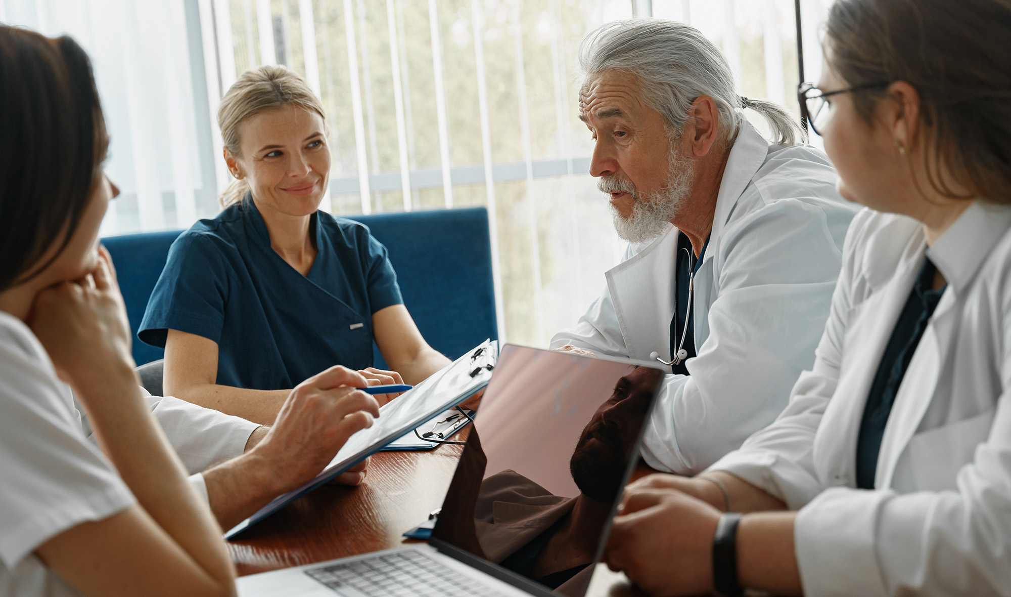 Image of healthcare professionals meeting and having a discussion. 