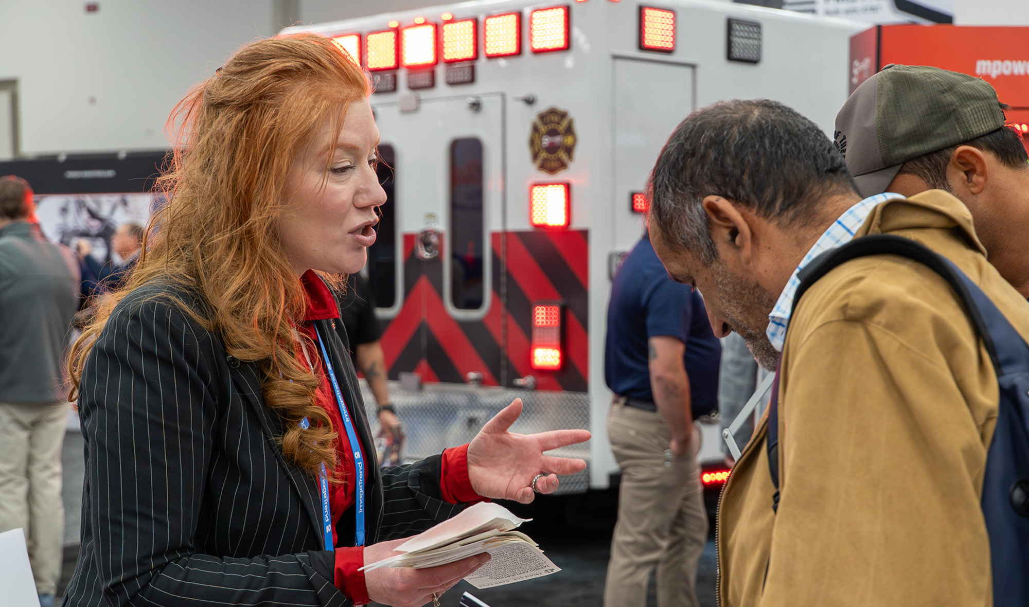 An image of an exhibitor speaking to attendees in the exhibit hall at EMS World Expo 2025.