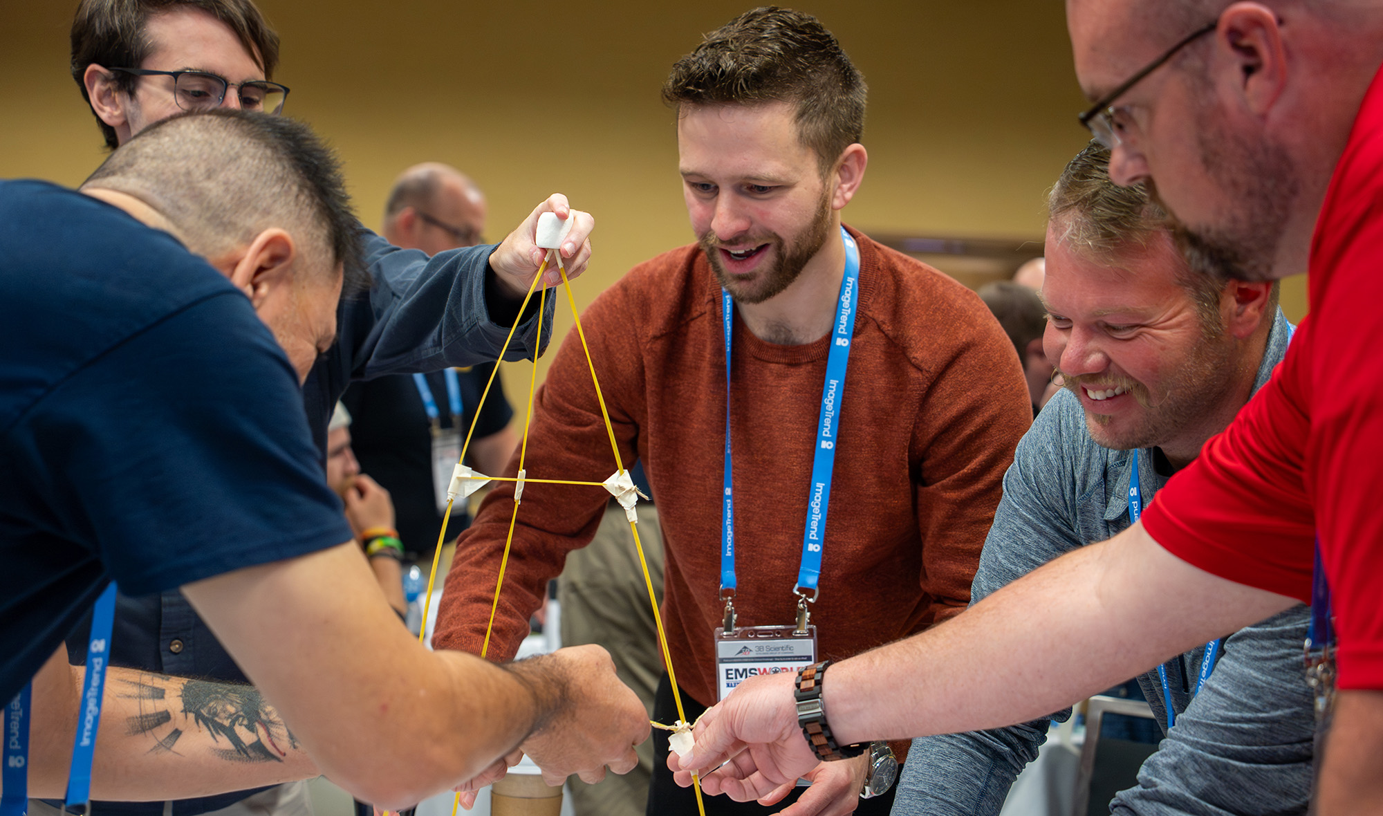 An image of attendees participating in a team building activity