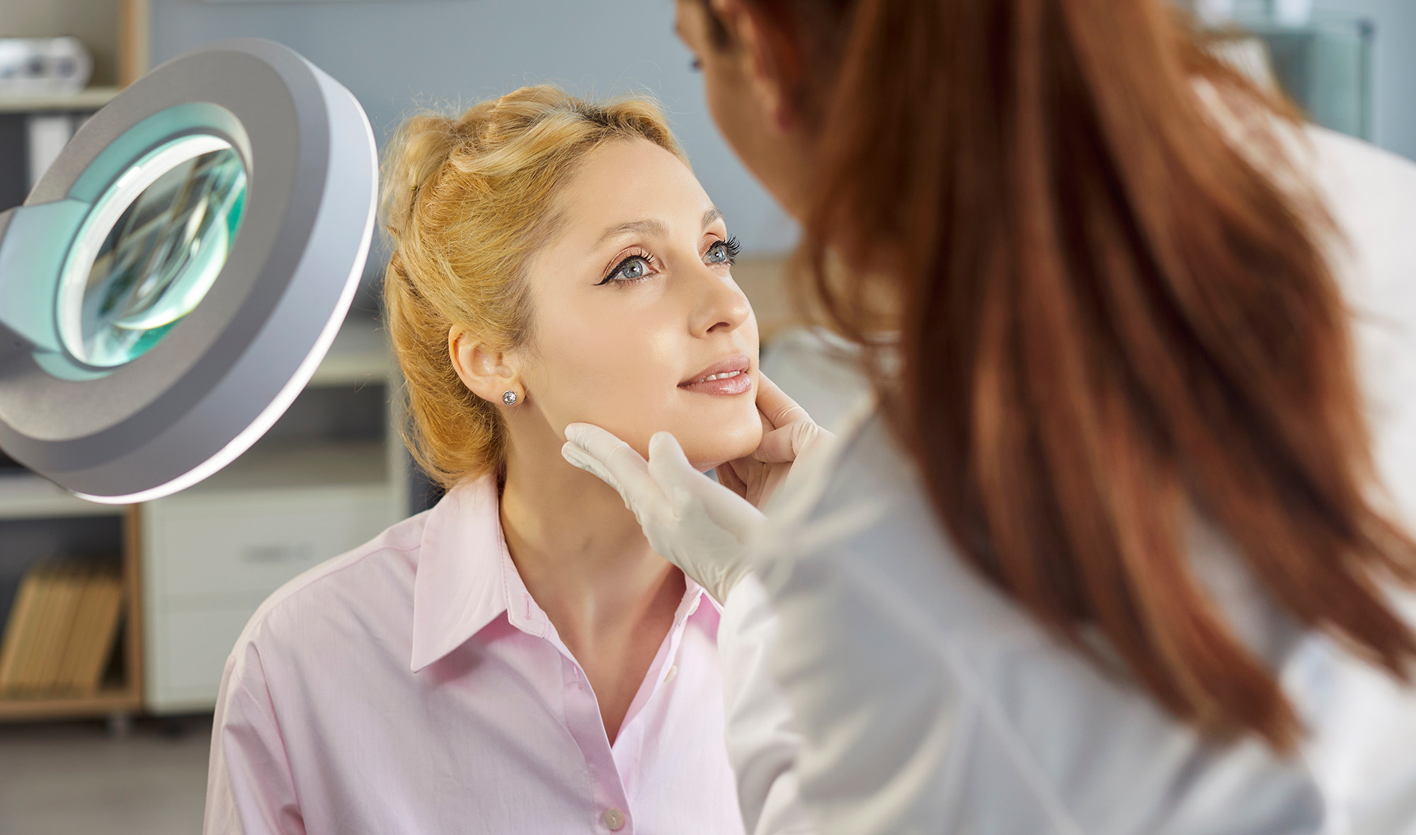Image of dermatologist examining a patient