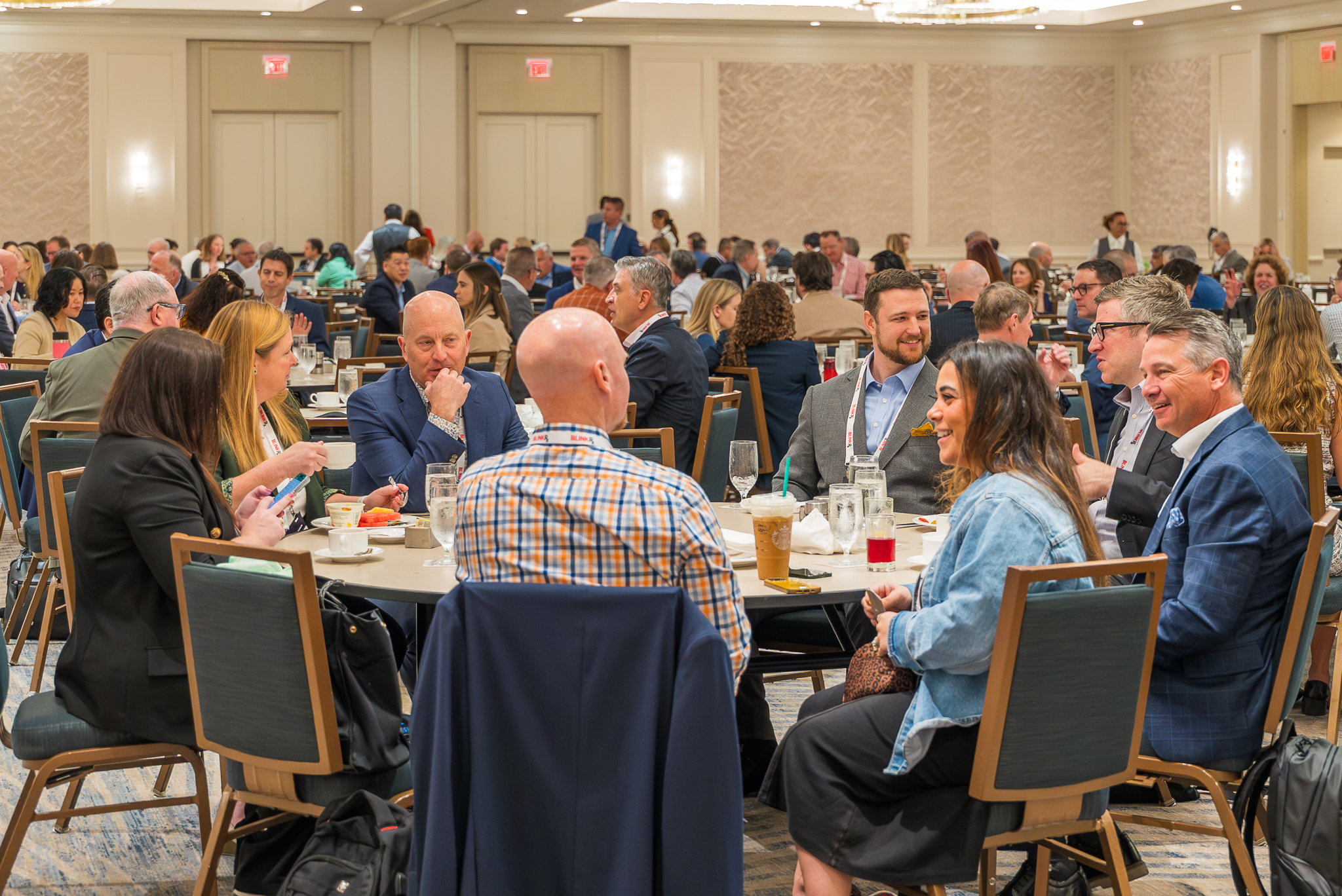 Attendees sitting and talking at a session