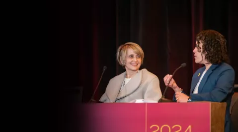 Two speakers at the podium debating