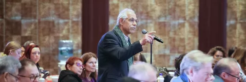 LL&M Congress attendee asking a question during a session. 