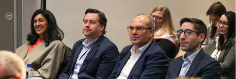 Attendees listening to debates