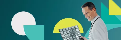 A stock image of a doctor reviewing an x-ray