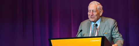 Dr Coleman speaking at podium