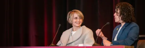 Two speakers at the podium debating