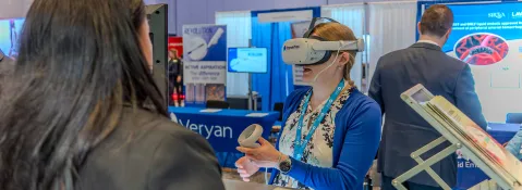 Attendee interacting with technology in the Exhibit Hall