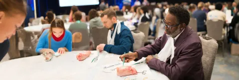 Attendees gaining practical wound care skills through hands-on learning at SAWC Spring | WHS.