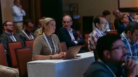 Attendee with a computer listening