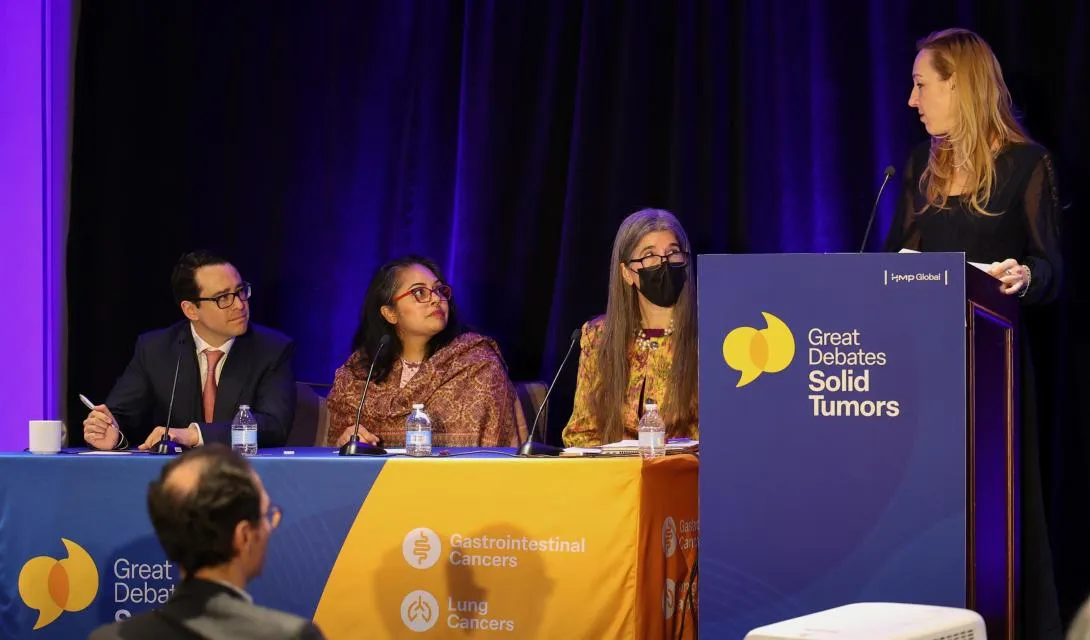 4 faculty members in debate on stage