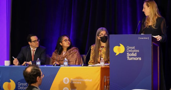 4 faculty members in debate on stage