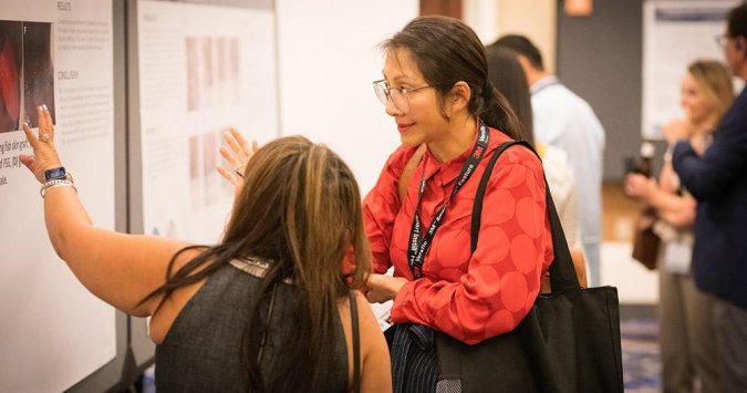 Two women looking at posters